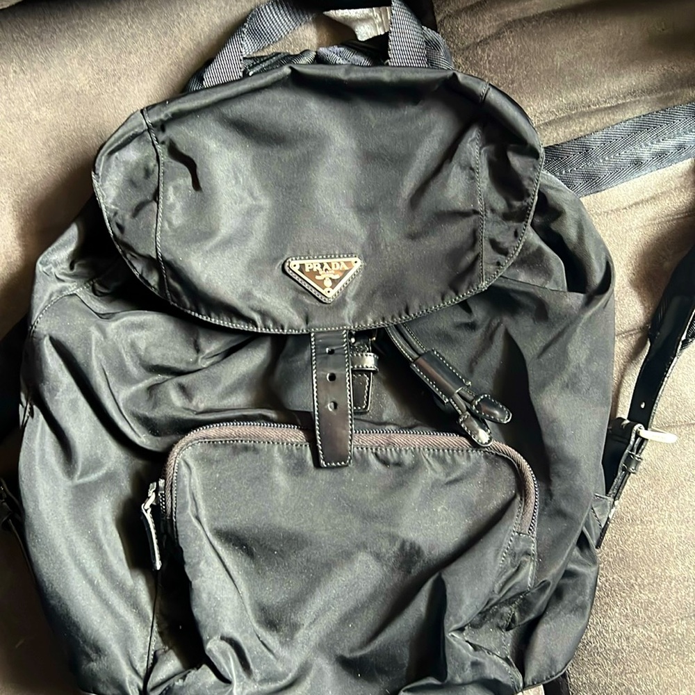 Prada backpack . Black with silver accents.